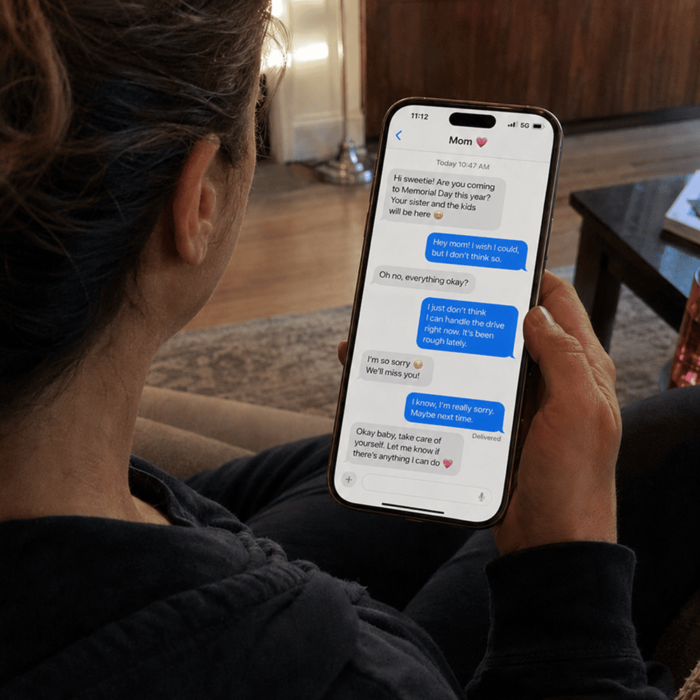 A person texting family about canceling a visit